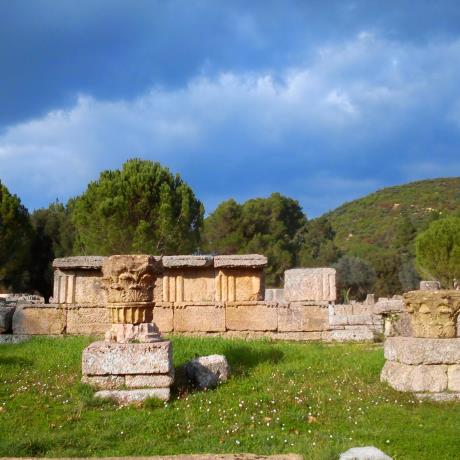 In a lush green landscape, the Kronion hill overlooks the ancient ruins., OLYMPIA (Ancient sanctuary) ILIA